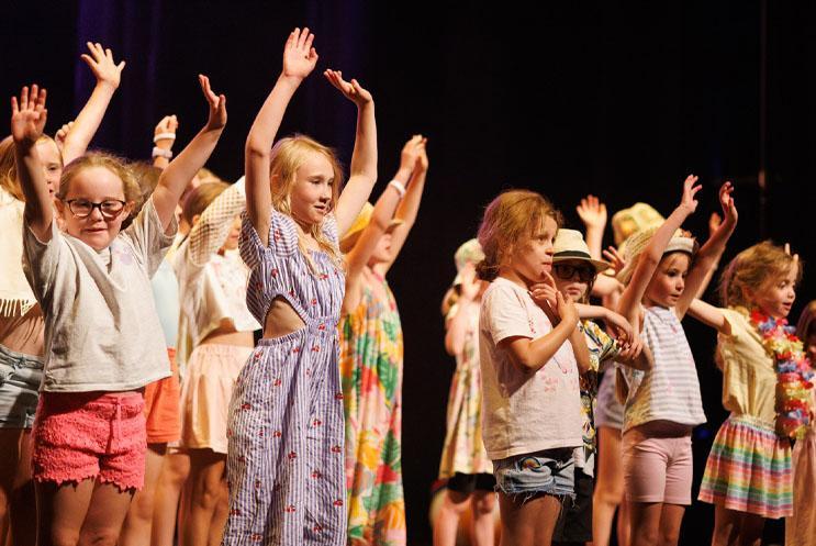 Young children performing on stage