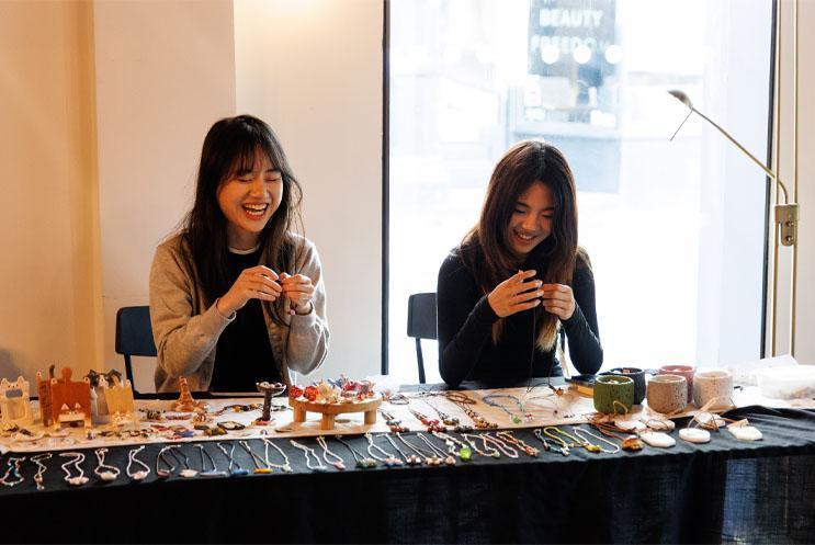 Young people behind a jewellery stall