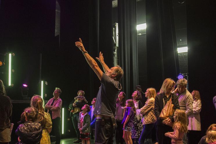 A group being given a tour on a theatre stage