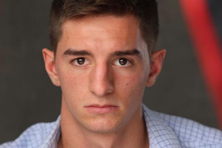 Headshot of man in white shirt looking at the camera