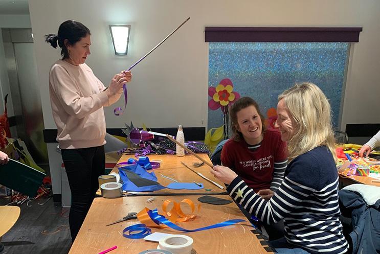 Teachers smiling and creating costumes