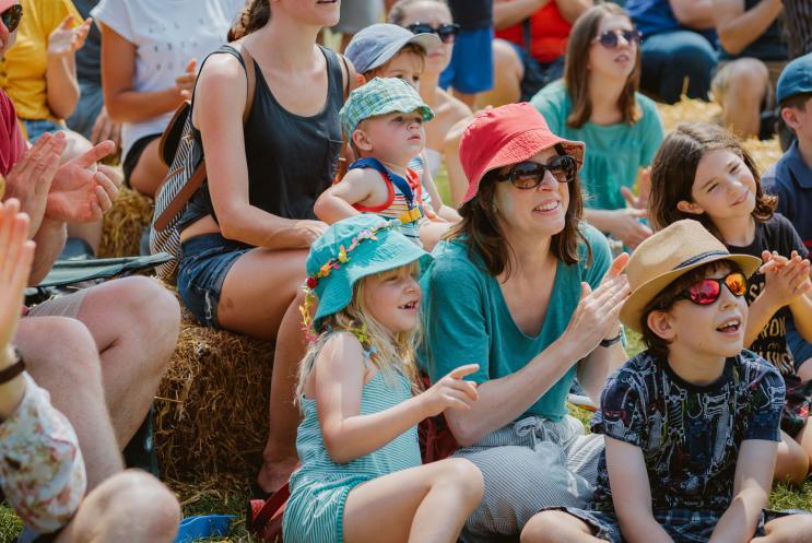 A family audience clapping and cheering.
