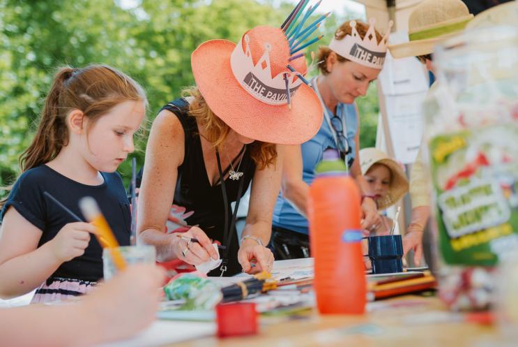 A family doing arts and crafts outdoors