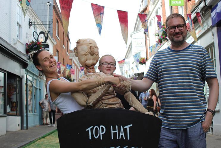 two female performancers shaking hands with male judge