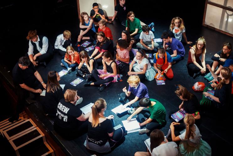 A group of people sitting together on a stage