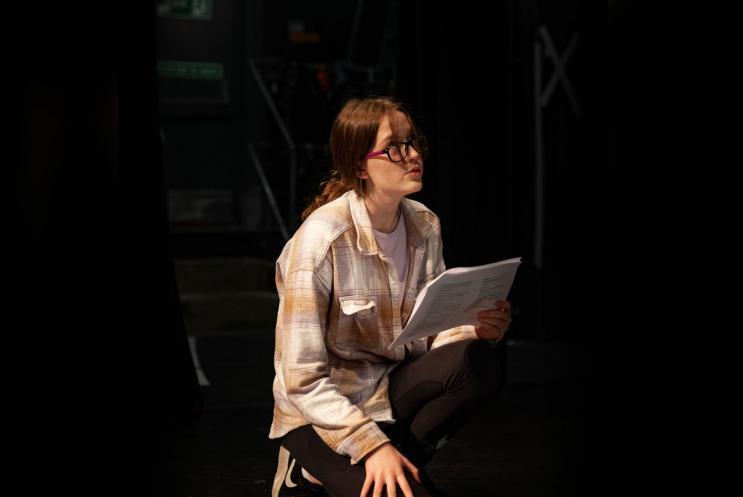 Young person reading a script