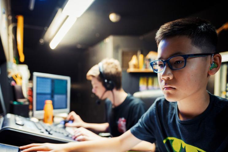 Two young boys working on the lighting desk
