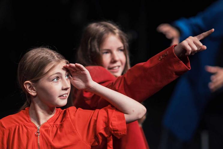 Girls on stage pointing